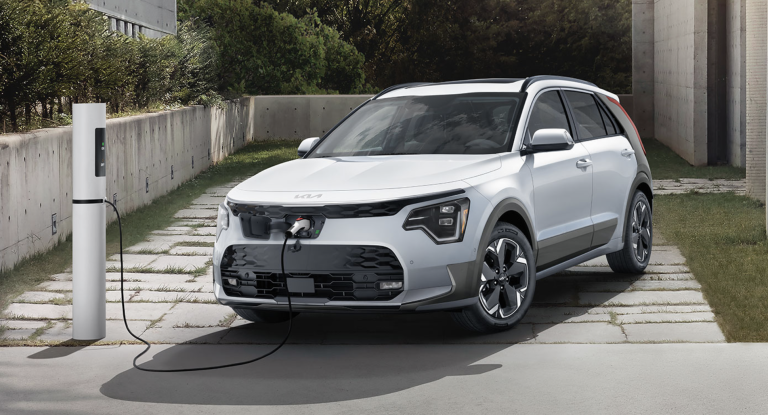 white Kia niro electric charging on driveway